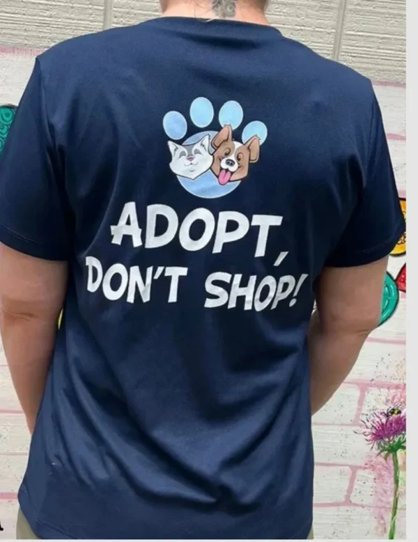 A person wearing a t-shirt that says adopt, don 't shop.